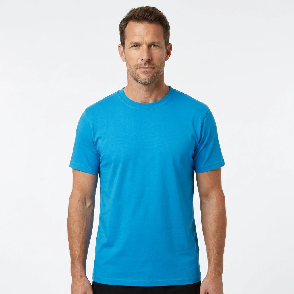 T-Time T-shirt, Turkis 0510 | Studio portrait of a 45-year-old man, athletic build, short brown hair, light stubble, neutral confident expression, standing against a plain white seamless stu