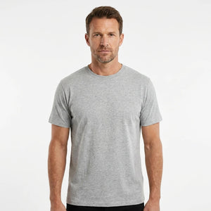 T-Time T-shirt, Grå melange 0510 | Studio portrait of a 45-year-old man, athletic build, short brown hair, light stubble, neutral confident expression, standing against a plain white seamless stu