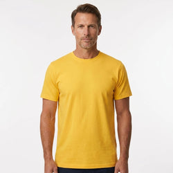 T-Time T-shirt, Gul 0510 | Studio portrait of a 45-year-old man, athletic build, short brown hair, light stubble, neutral confident expression, standing against a plain white seamless stu