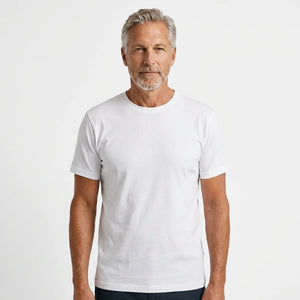 T-Time T-shirt, Hvid 0510 | Studio portrait of a 45-year-old man, athletic build, short brown hair, light stubble, neutral confident expression, standing against a plain white seamless stu