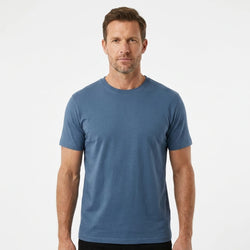T-Time T-shirt, Indigo Blå 0510 | Studio portrait of a 45-year-old man, athletic build, short brown hair, light stubble, neutral confident expression, standing against a plain white seamless stu