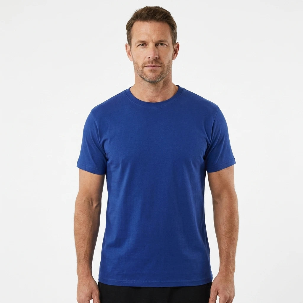 T-Time T-shirt, Kongeblå 0510 | Studio portrait of a 45-year-old man, athletic build, short brown hair, light stubble, neutral confident expression, standing against a plain white seamless stu
