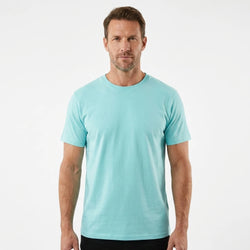 T-Time T-shirt, Mint 0510 | Studio portrait of a 45-year-old man, athletic build, short brown hair, light stubble, neutral confident expression, standing against a plain white seamless stu