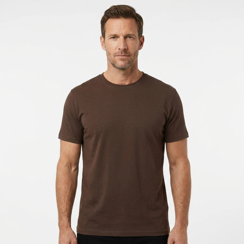 T-Time T-shirt, Mocca/Brun 0510 | Studio portrait of a 45-year-old man, athletic build, short brown hair, light stubble, neutral confident expression, standing against a plain white seamless stu