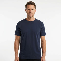 T-Time T-shirt, Navy Blå 0510 | Studio portrait of a 45-year-old man, athletic build, short brown hair, light stubble, neutral confident expression, standing against a plain white seamless stu
