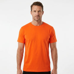 T-Time T-shirt, Orange 0510 | Studio portrait of a 45-year-old man, athletic build, short brown hair, light stubble, neutral confident expression, standing against a plain white seamless stu