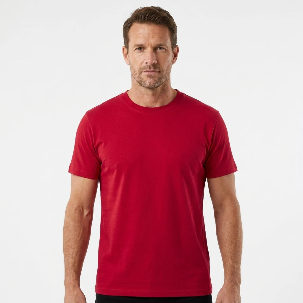 T-Time T-shirt, Rød 0510 | Studio portrait of a 45-year-old man, athletic build, short brown hair, light stubble, neutral confident expression, standing against a plain white seamless stu