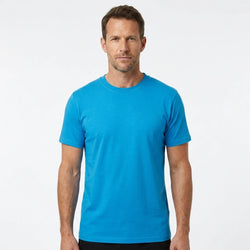 T-Time T-shirt, Turkis 0510 | Studio portrait of a 45-year-old man, athletic build, short brown hair, light stubble, neutral confident expression, standing against a plain white seamless stu